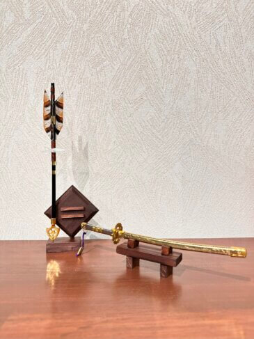 人形の河田から手作りのお道具が登場！ 王道の太刀と、短檠と矢を組み合わせた モダンなお飾りで兜をおしゃれに。 このお道具は河田オリジナルの兜シリーズ、Hanaemi Yorisoi に使用しております。